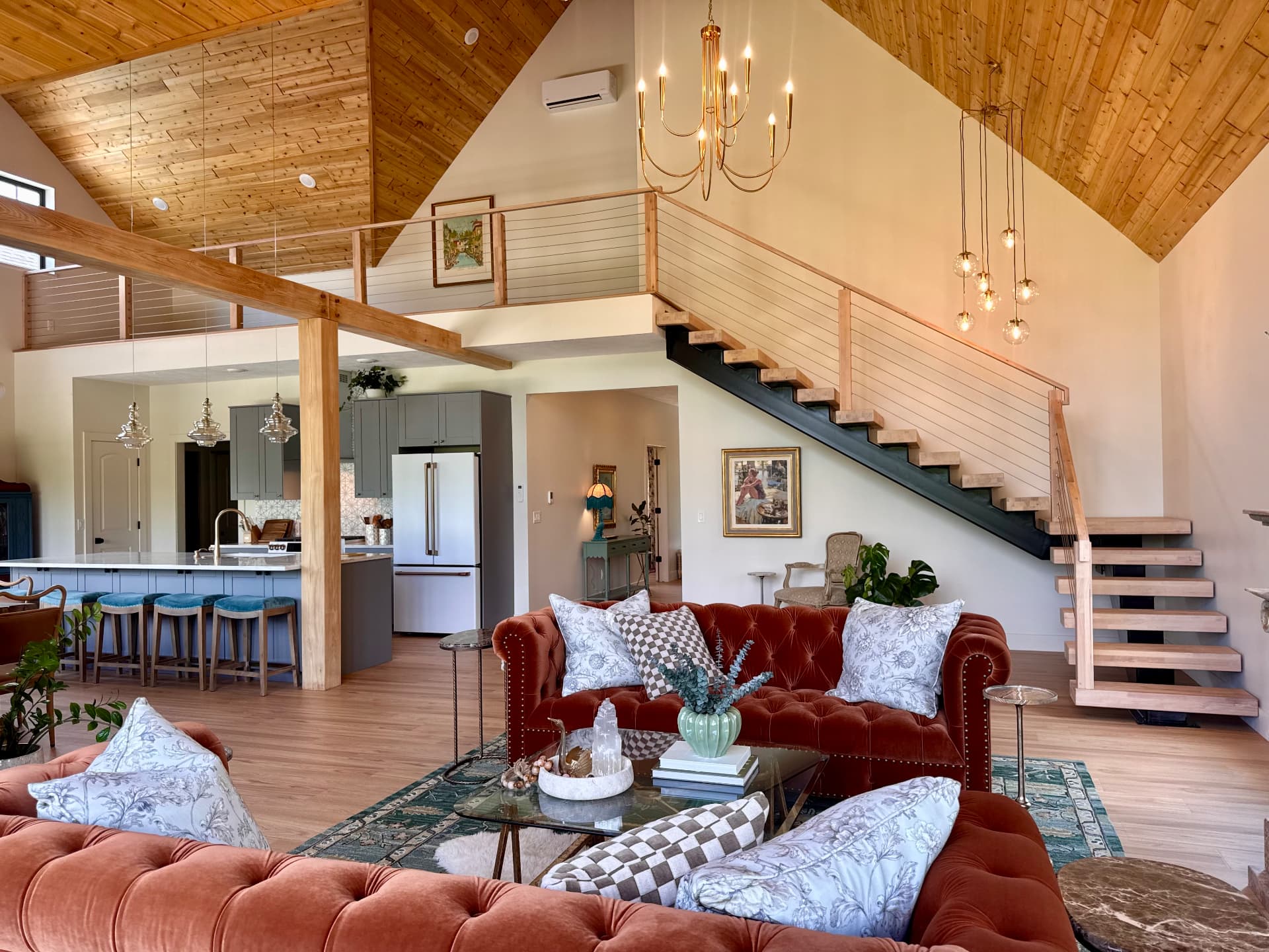 Tufted sofas and the staircase in the living room